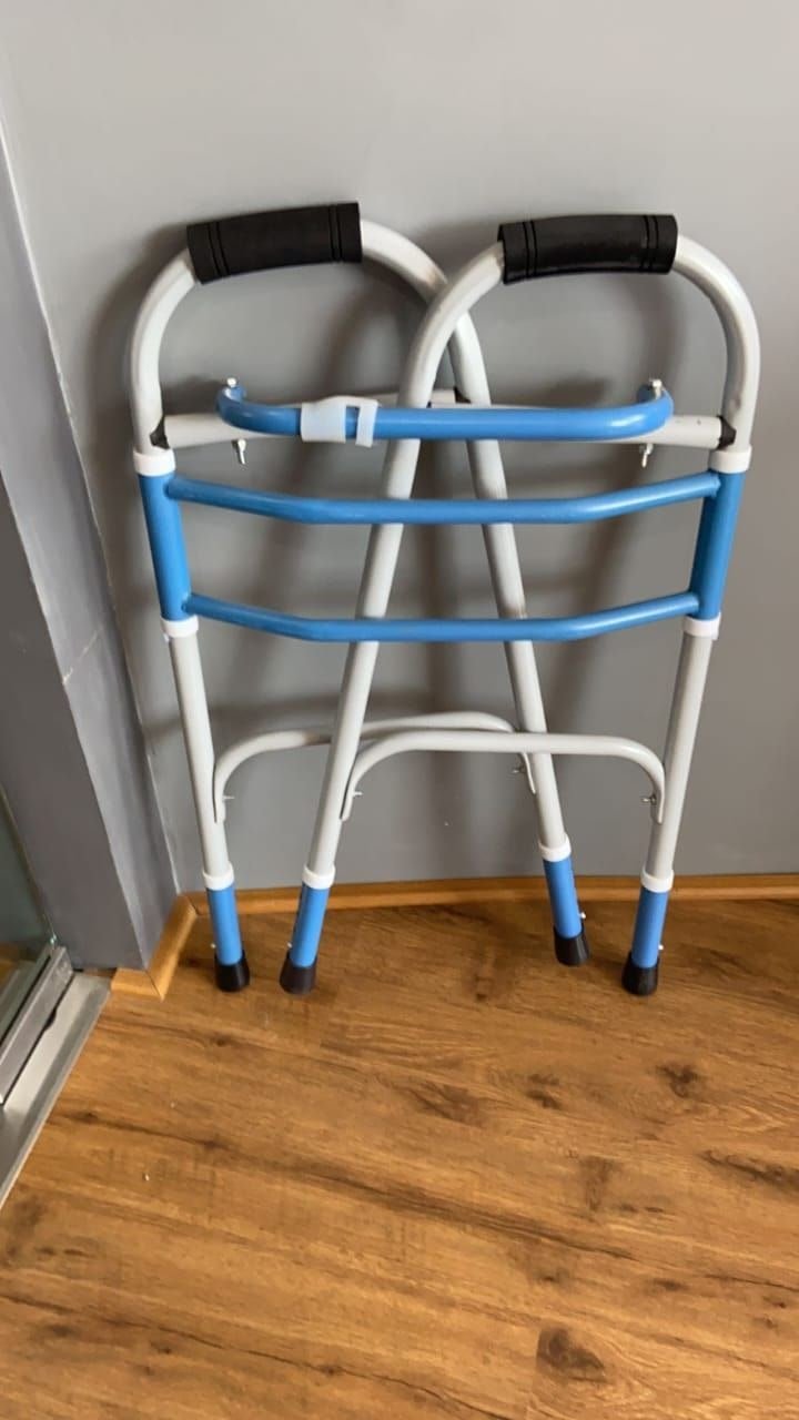 Blue and white folding walker, folded flat